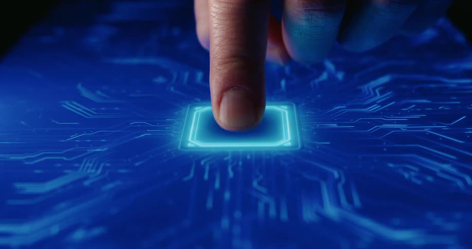 Finger pressing a glowing chip on a blue board with circuit traces