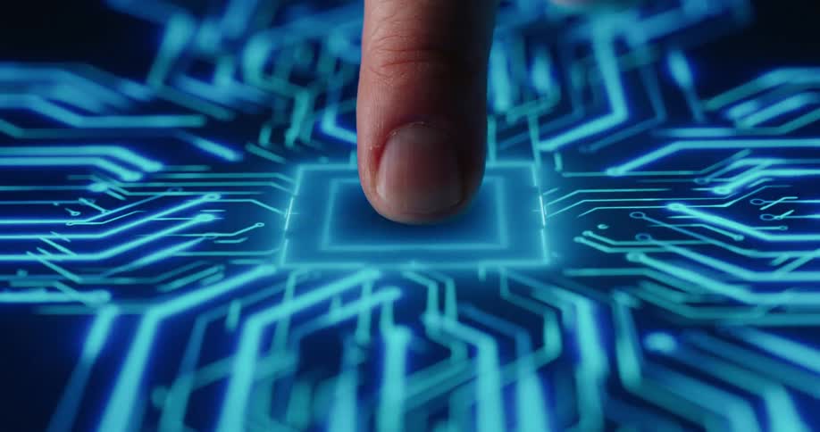 A finger presses a glowing blue button embedded in a futuristic circuit board interface