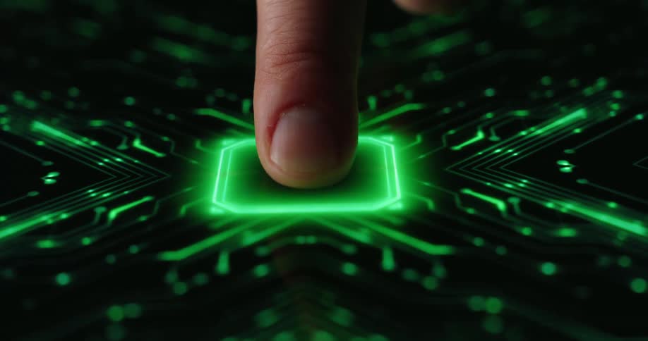A finger presses down onto a dark reflective surface triggering the appearance of a glowing green squareas contact is maintained a complex network of neon green circuitry pulses outward across the entire screen