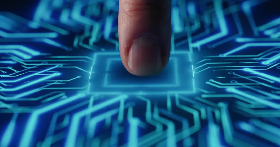 A closeup of a finger pressing a glowing blue digital interface that resembles a futuristic processor as the contact is made vibrant light patterns spread outward like electric circuits across a dark background