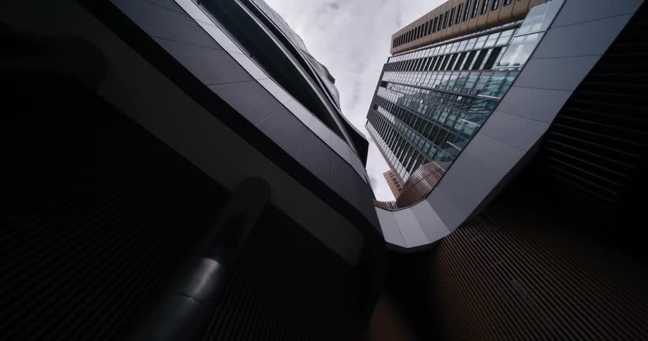 Perspective of modern buildings with glass and metal facades seen from below