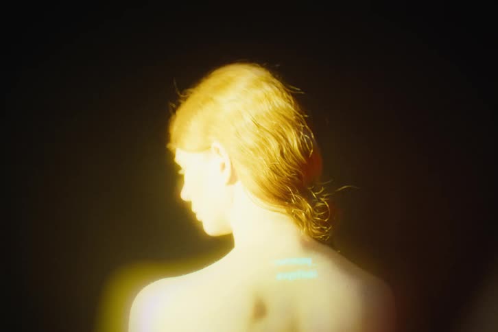 Flashing lights with words appear on the womans back
