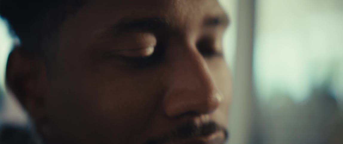 A close up of a man sitting in a room