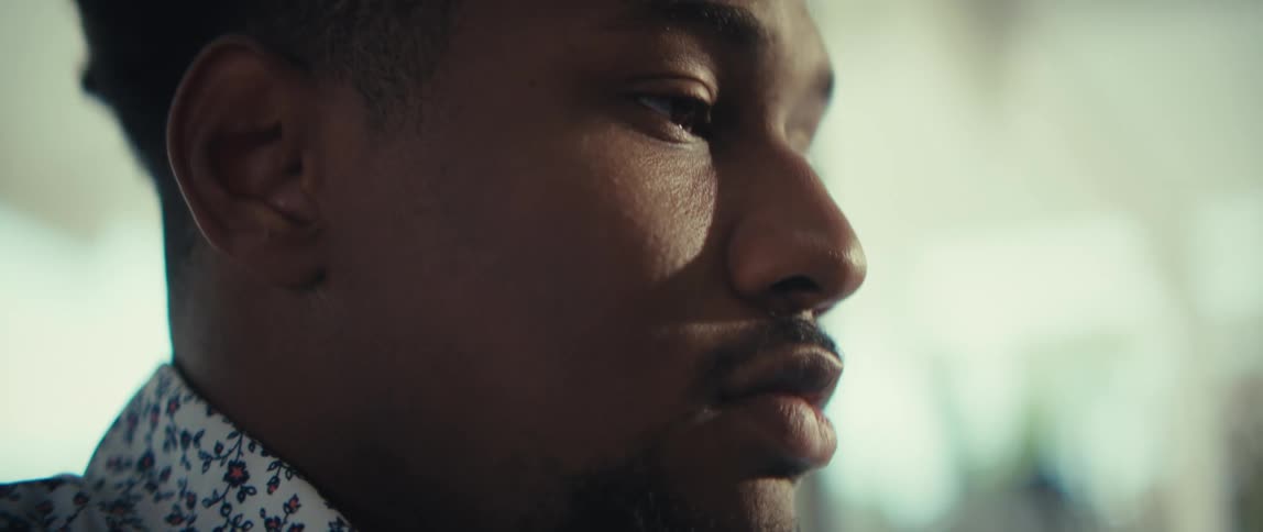 A close up profile of a man looking thoughtfully off camera