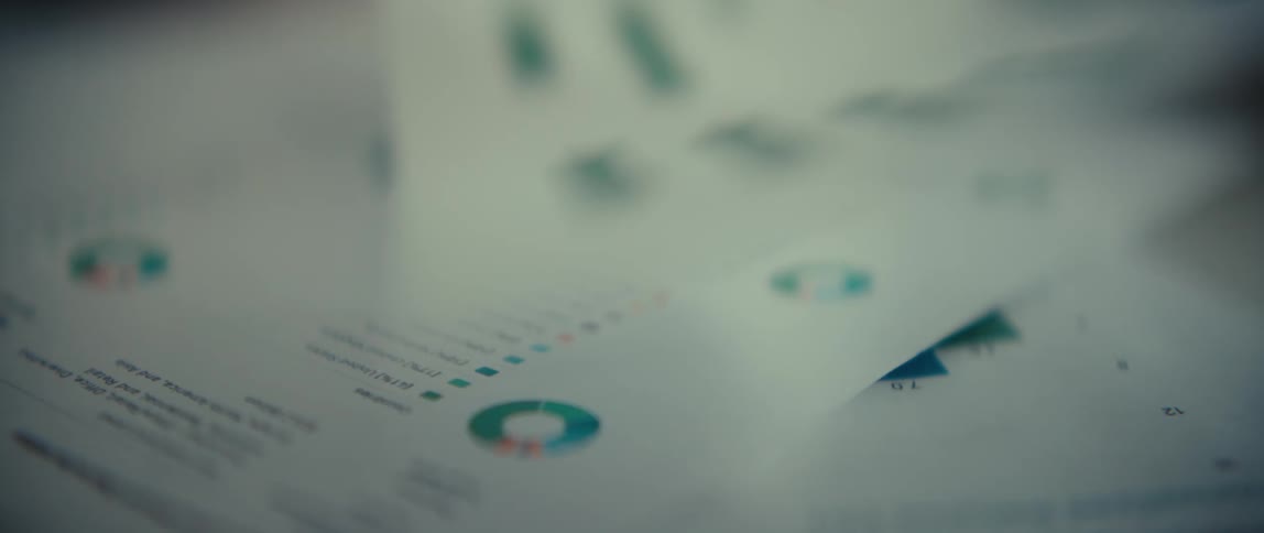 Document with a bar chart and financial data in selective focus