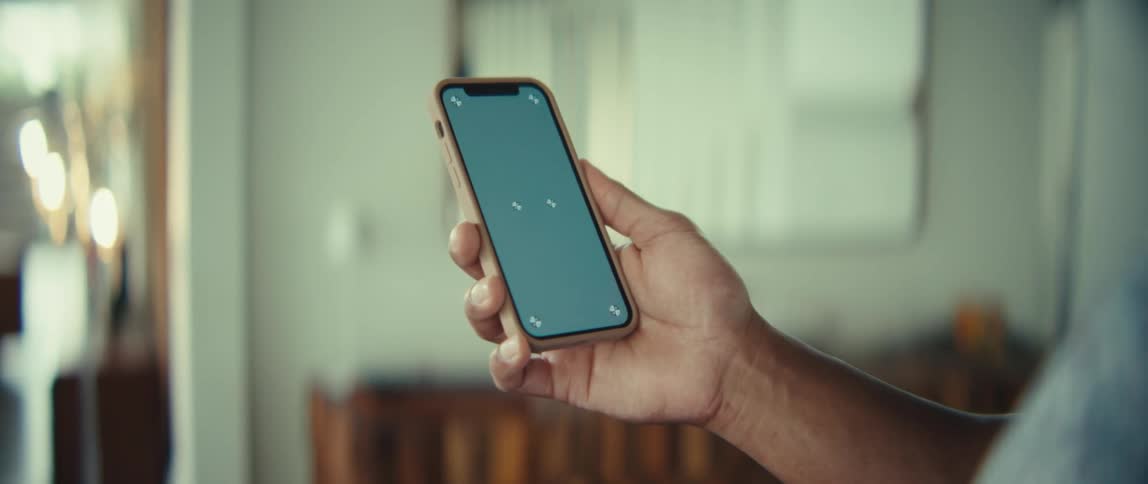 A man using a smartphone in a room