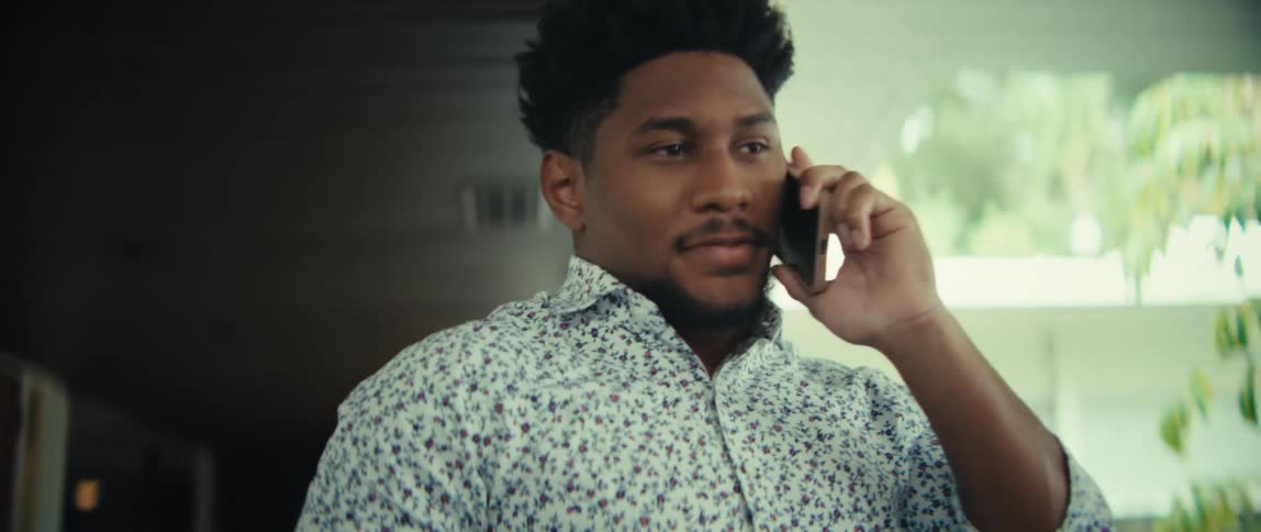 The man talks on the phone then cheers