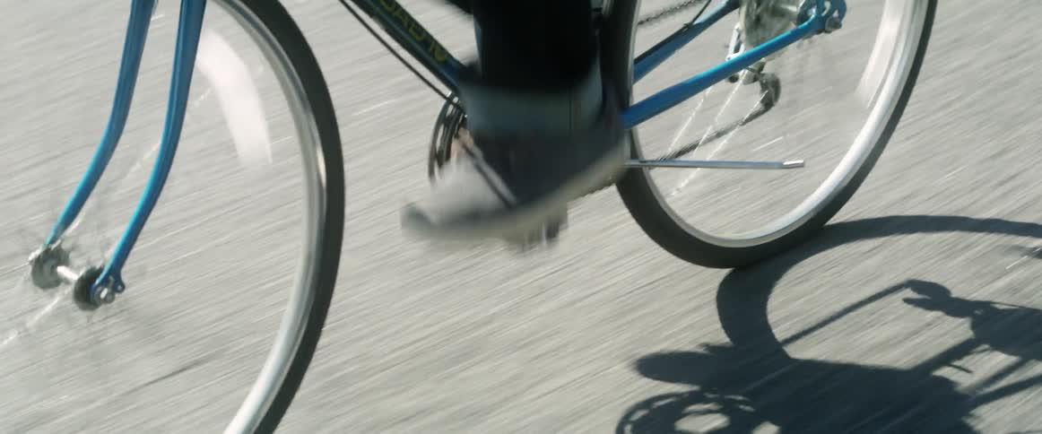 Person pedaling a bicycle down a street