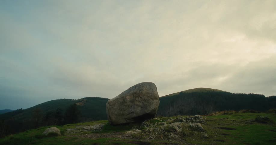 A large rock on the top of a mountain