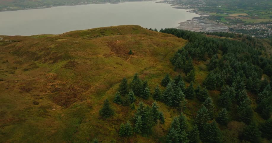 Aerial of a mountaintop next to a large lake