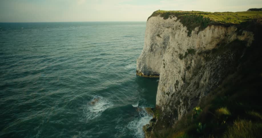White cliff rising above the blue sea