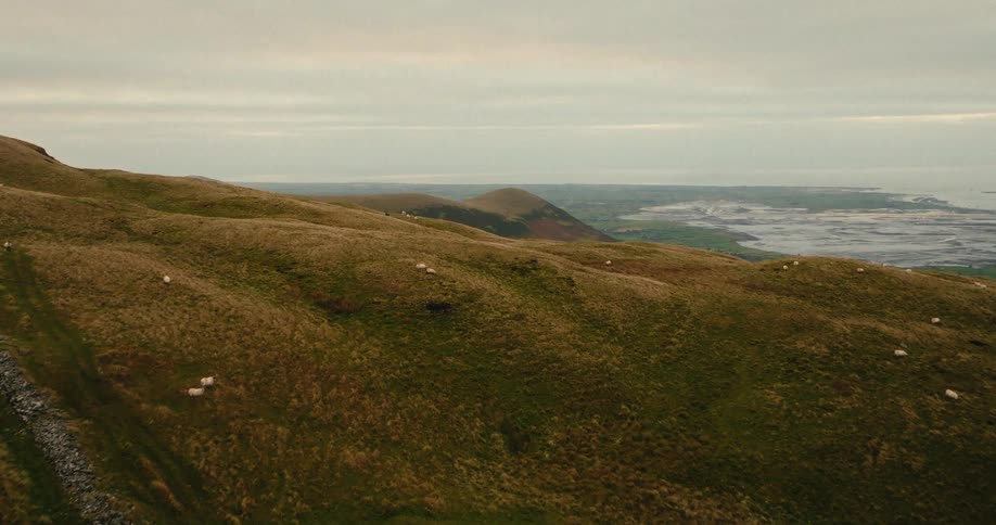 An aerial view of some hills next to a coast