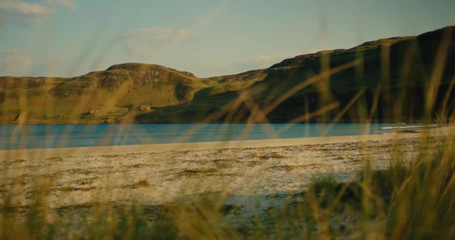 The blue water is near the green hills