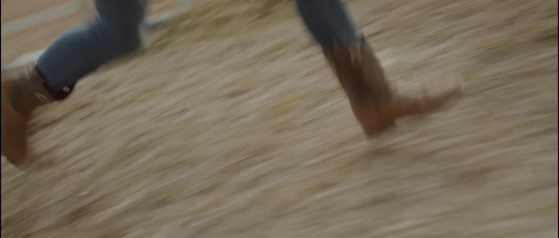 Legs wearing brown boots running