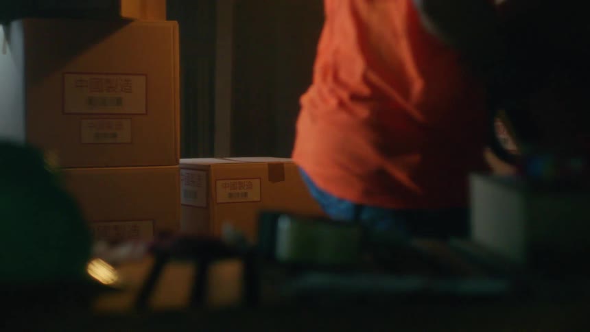 People stack boxes in a warehouse