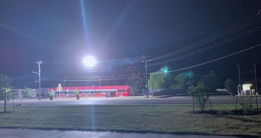A view of a transformer blowing up outdoors at night