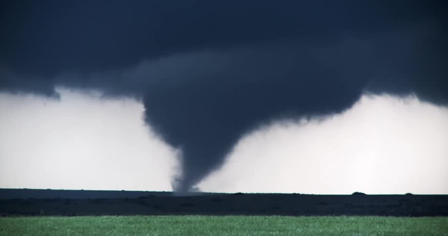 A view of a tornado out in a field