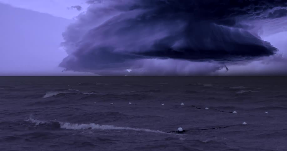 A massive dark supercell cloud looms over a turbulent sea illuminated by a single powerful bolt of lightning that strikes the horizon the choppy water is filled with white buoys strung together on a line emphasizing the scale and intensity of the app