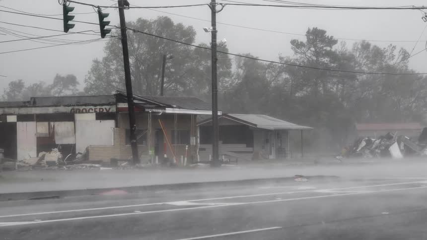 The storm rips through the town destroying a store building