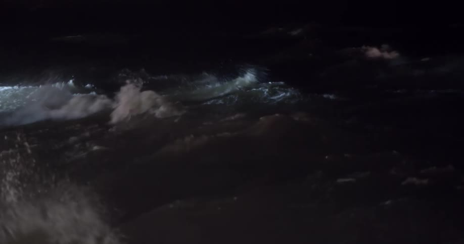 A view of waves in the ocean at night