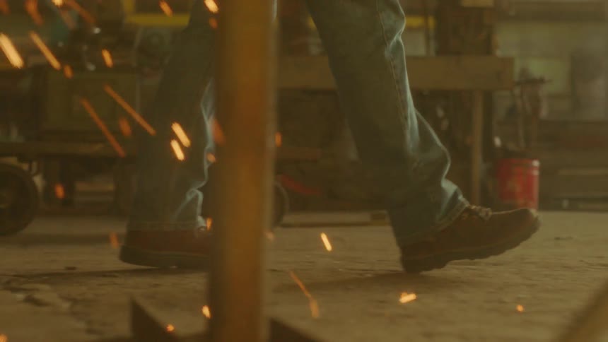A man walks by sparks flying to the ground