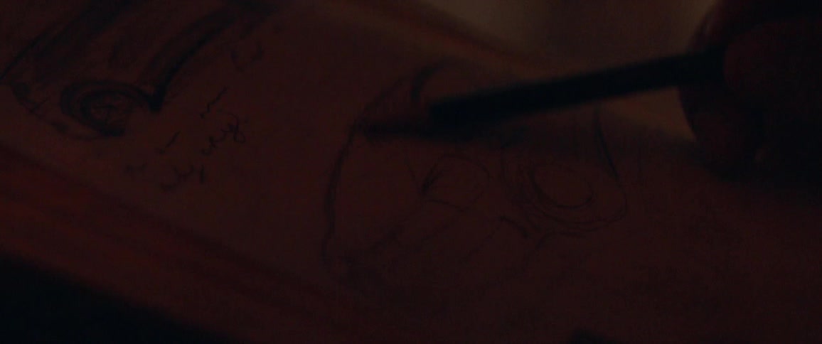 An artist sketches in a notepad