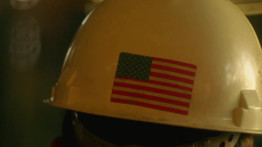 An american flag sticker affixed to the back of a hard hat