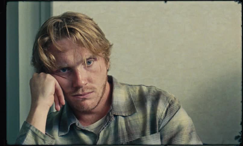 A portrait of a man sitting around thinking