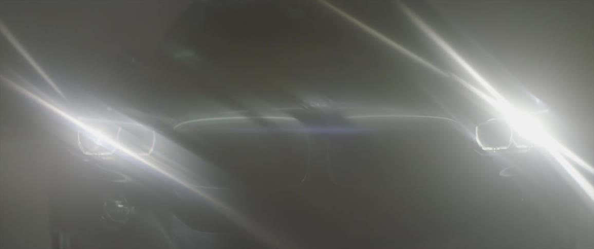 A car's headlights shine and reflect at night
