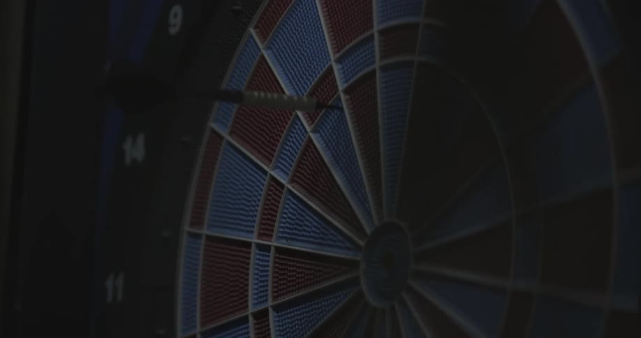 A dartboard has a dart embedded in it