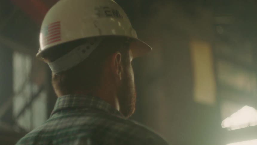 A man wears a hardhat on a worksite