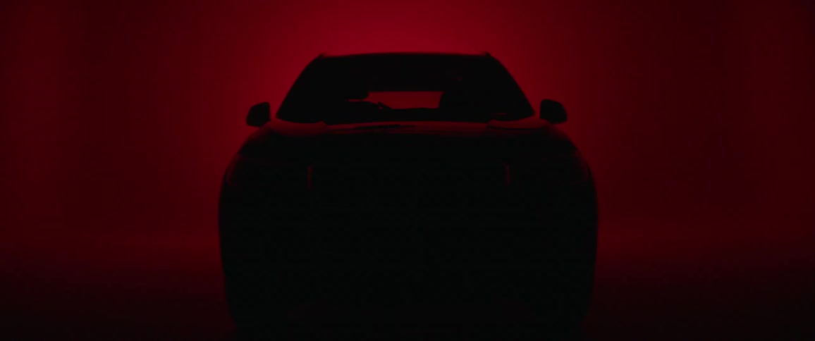 A car sits in a red room