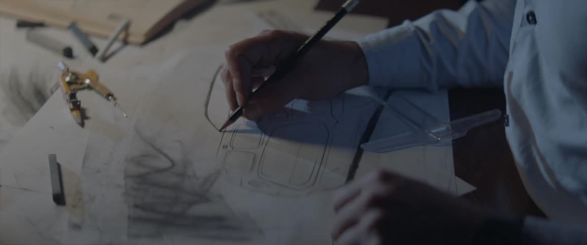 A person sketches a car