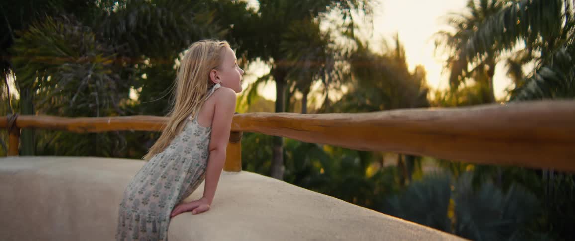 A portrait of a child outdoors on a sunny day