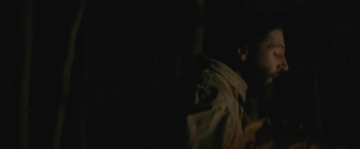 A man dances around outside at night
