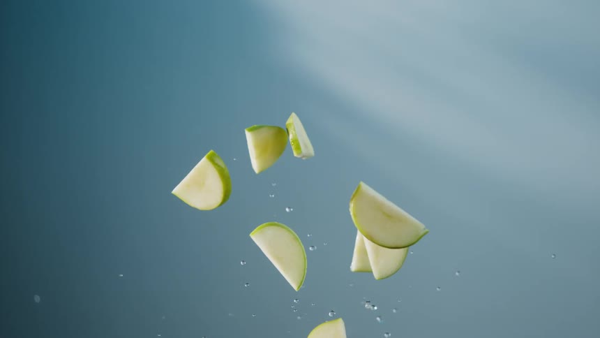 The slices of apple fly up