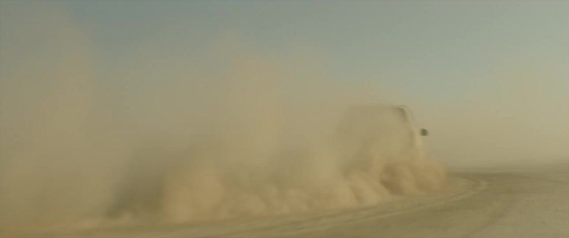 A car turns fast in the sand