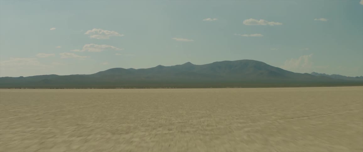 A large and empty expanse is surrounded by mountains