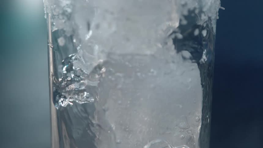 Ice cubes submerged in liquid inside a glass