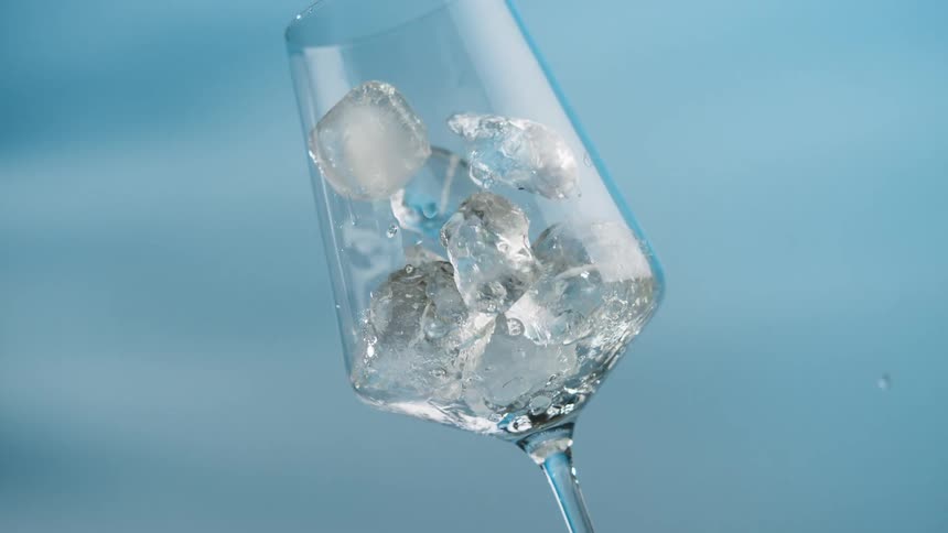Ice falls to fill the glass