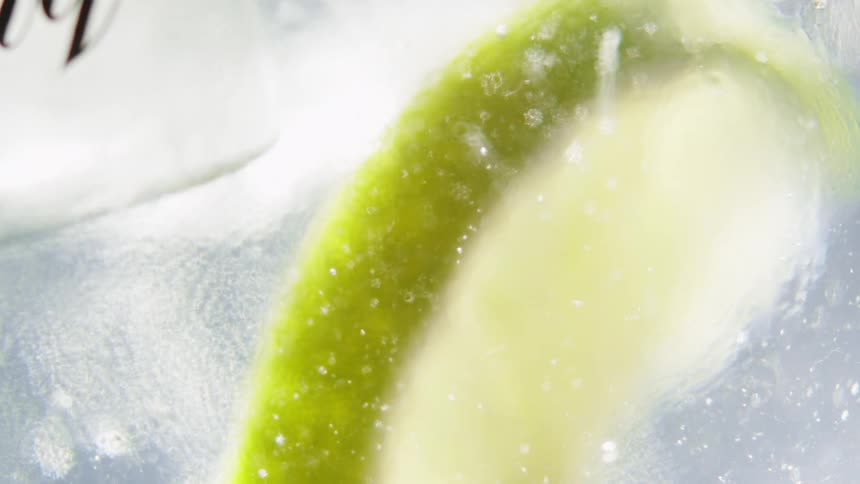 Slice of lemon and ice in a glass with a liquid