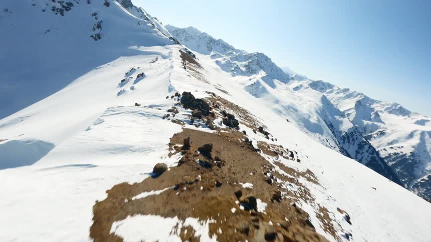 An aerial view of a mountain top covered in snow