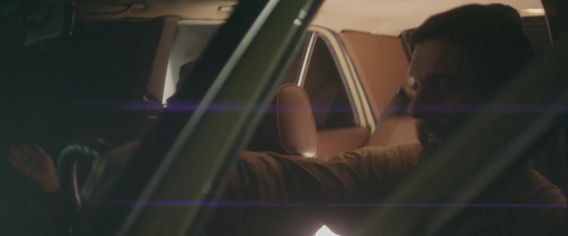 A woman grooves in the front seat of a car