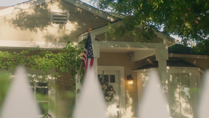 A house with an american flag hanging outside