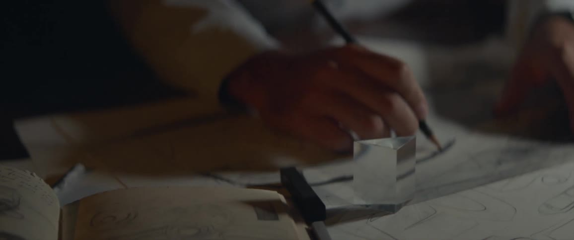 A man sketches with a pencil