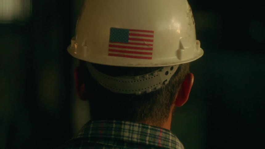 A man wears a helmet with a flag on it