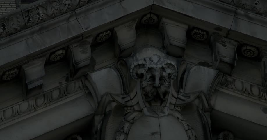 Stone mural of a man on side of old building