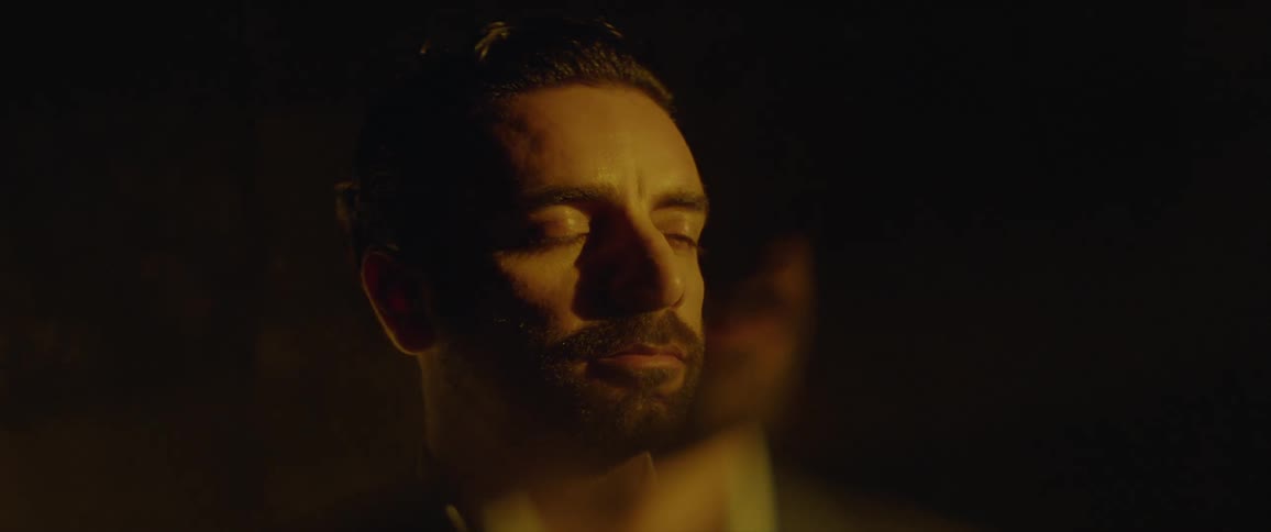 A man stares out and blinks as light passes in front of him