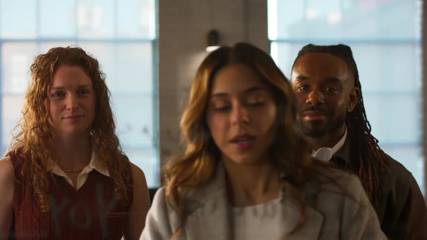 Three coworkers talking in an office together