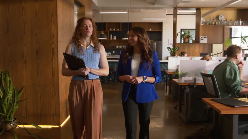 A few coworkers talking in an office together